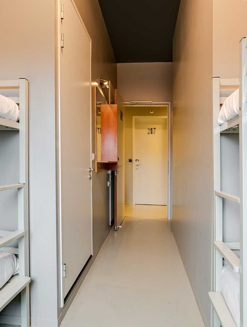 A dorm room at ClinkNOORD hostel in Amsterdam facing the hallway 