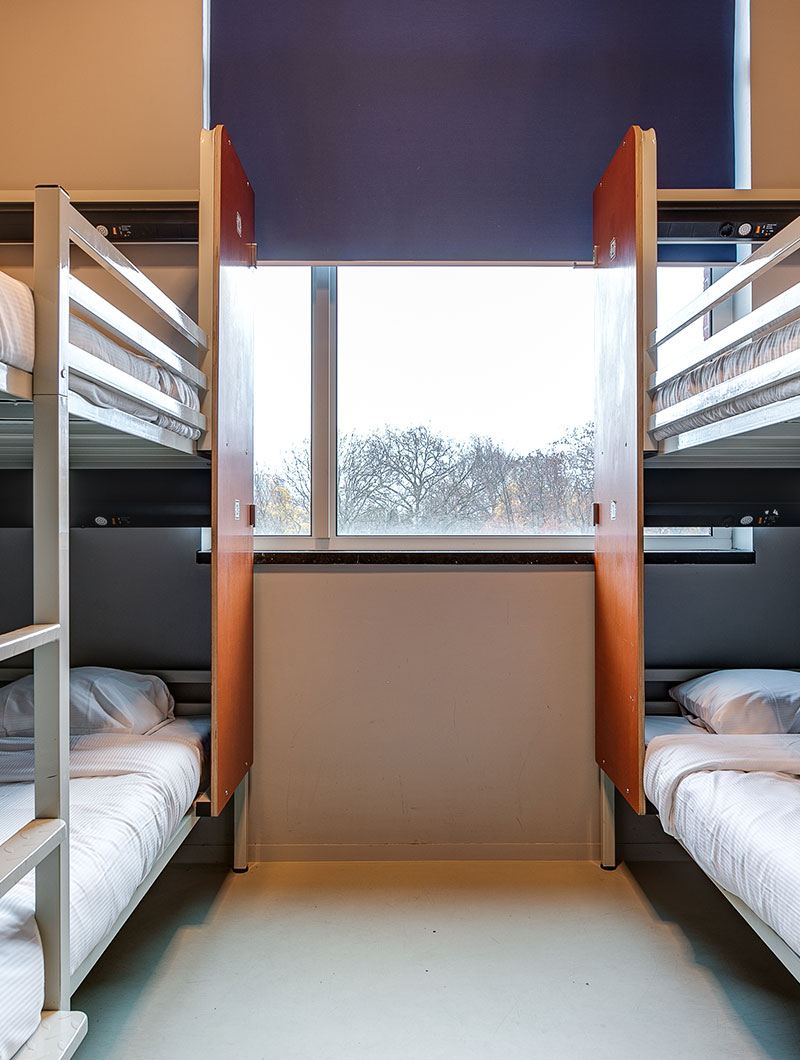 Bunk beds and a window at ClinkNOORD hostel in Amsterdam