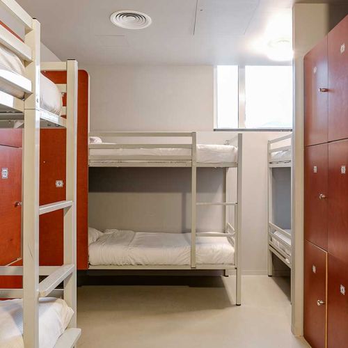 dorm beds at ClinkNOORD in Amsterdam with lockers for guests' luggage