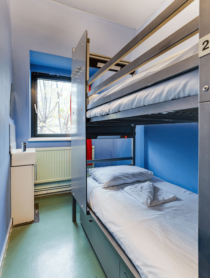 A private twin room at Clink 261 hostel in London with a set of bunk beds