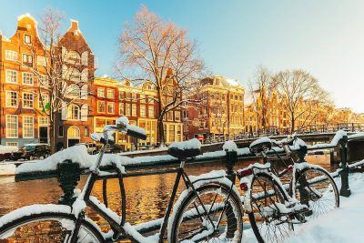 snow on a bike at a canal in Amsterdam