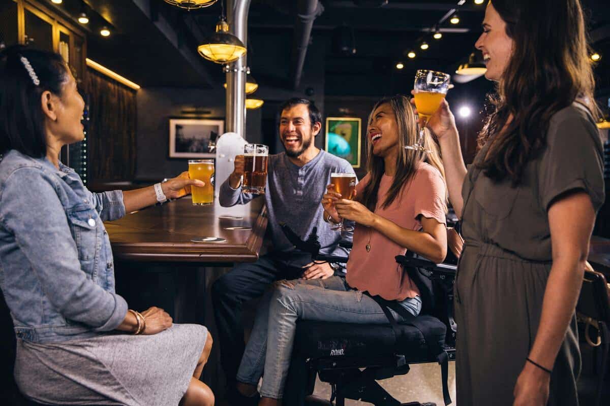 People laughing whilst drinking beer.