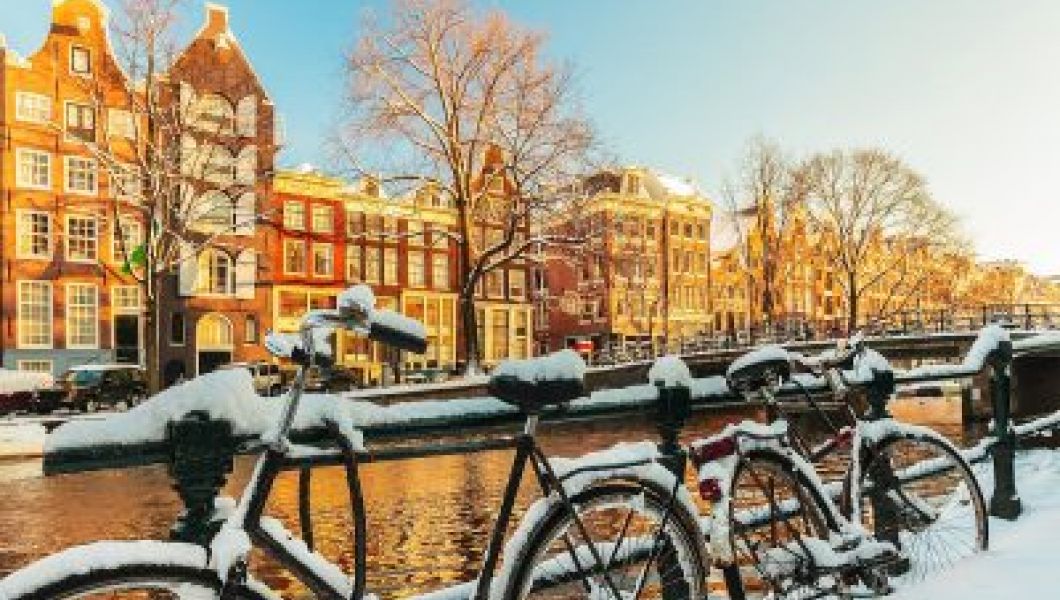 snow on a bike at a canal in Amsterdam