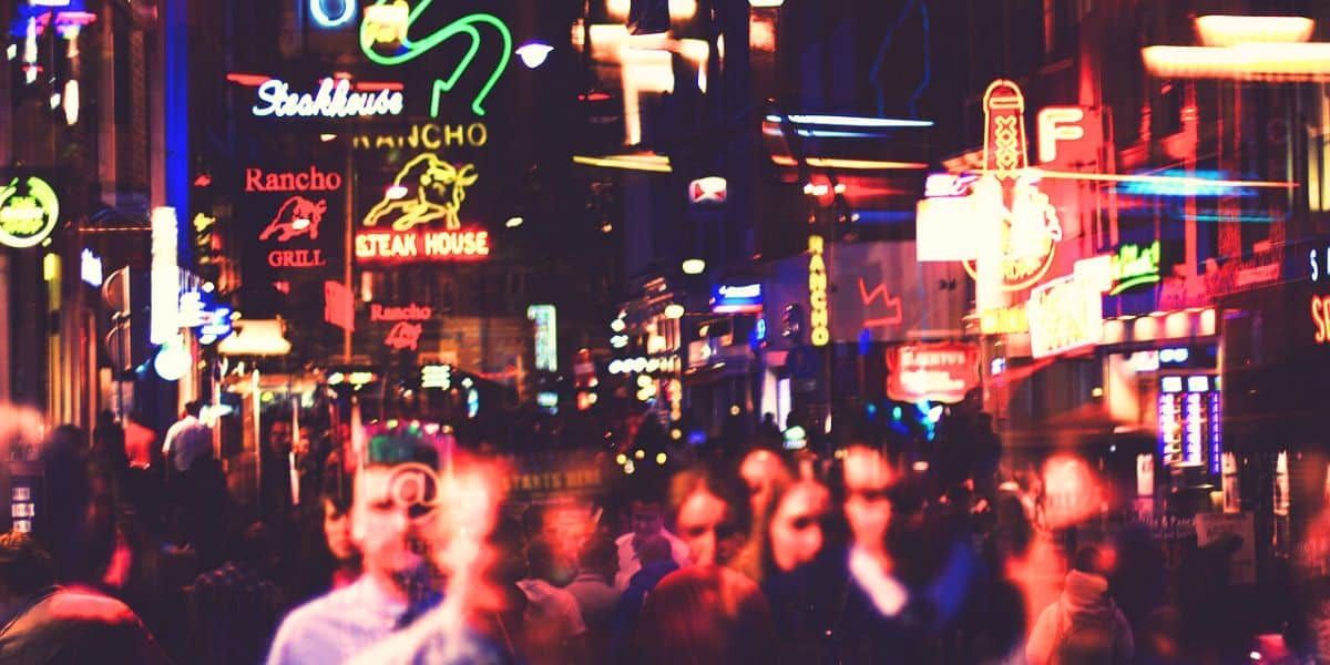 a busy street at night in amsterdam