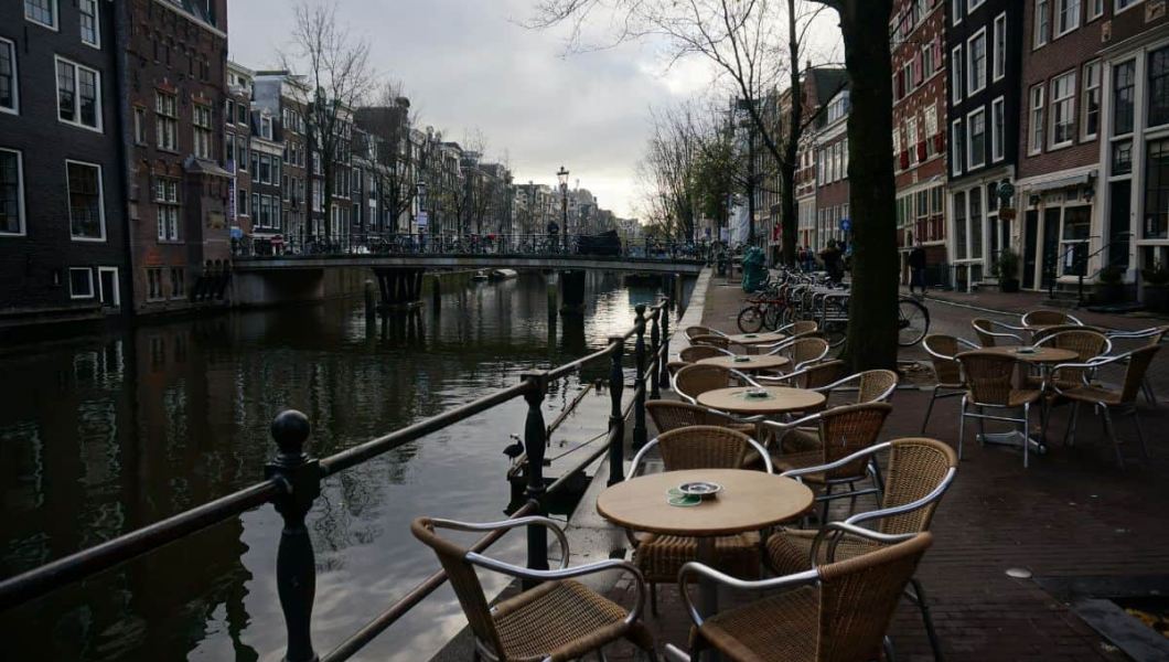 a bar by a canal in amsterdam