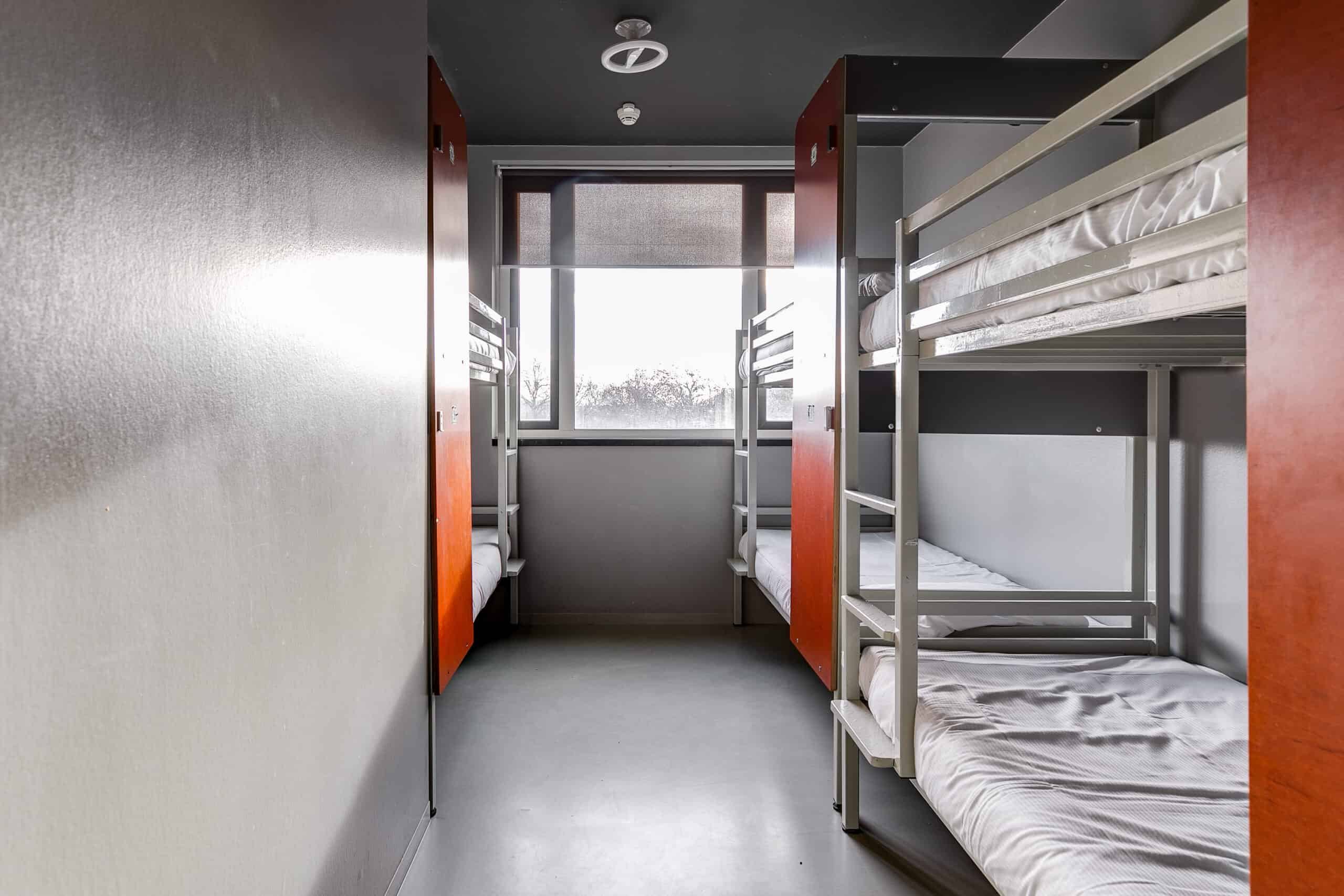 Dorm room with bunk beds and lockers at Clinknoord hostel Amsterdam