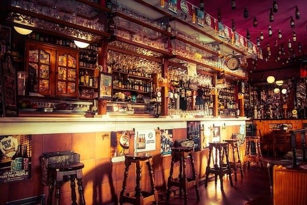 bar with alcohol stacked on shelves