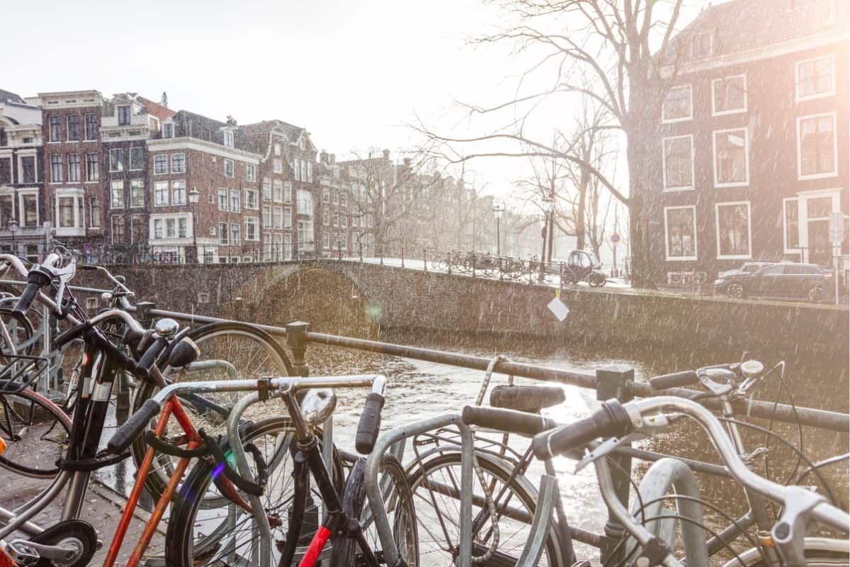 bikes on a canal in the rain in amsterdam