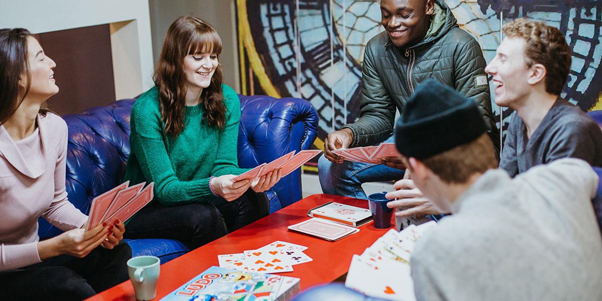 friends gathered in Clink 261 enjoying board games and playing cards