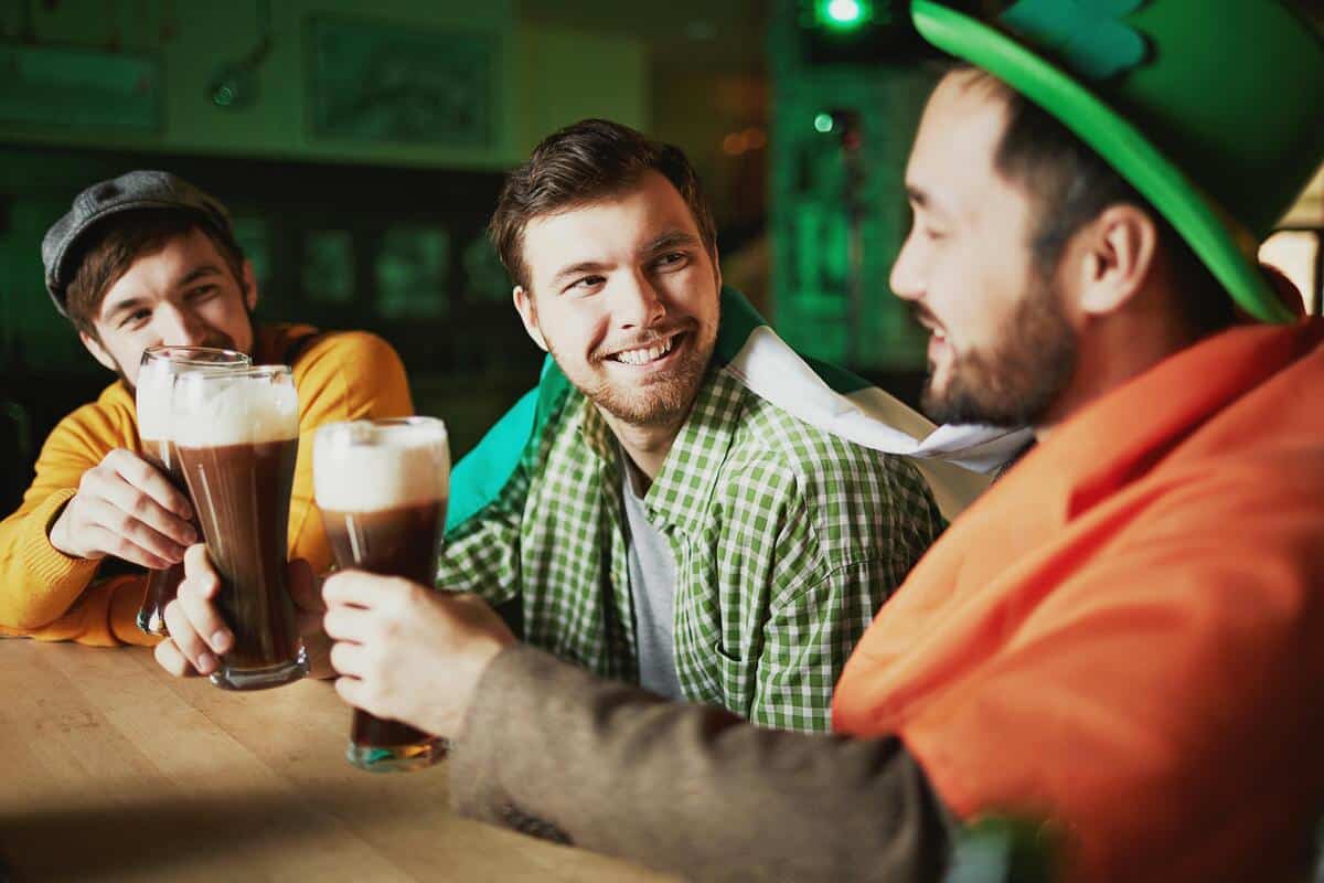 3 men in a pub drinking beer and celebrating St. Patrick's Day