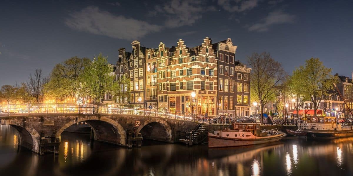 one of the many canals in Amsterdam at night time