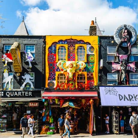 A famous red London Bus driving on Liverpool Street with Clink Hostels advert for Female Dorms added to it.