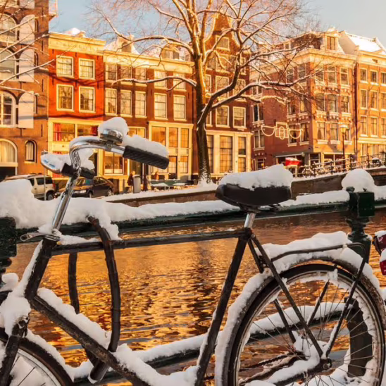 snow on a bike at a canal in Amsterdam