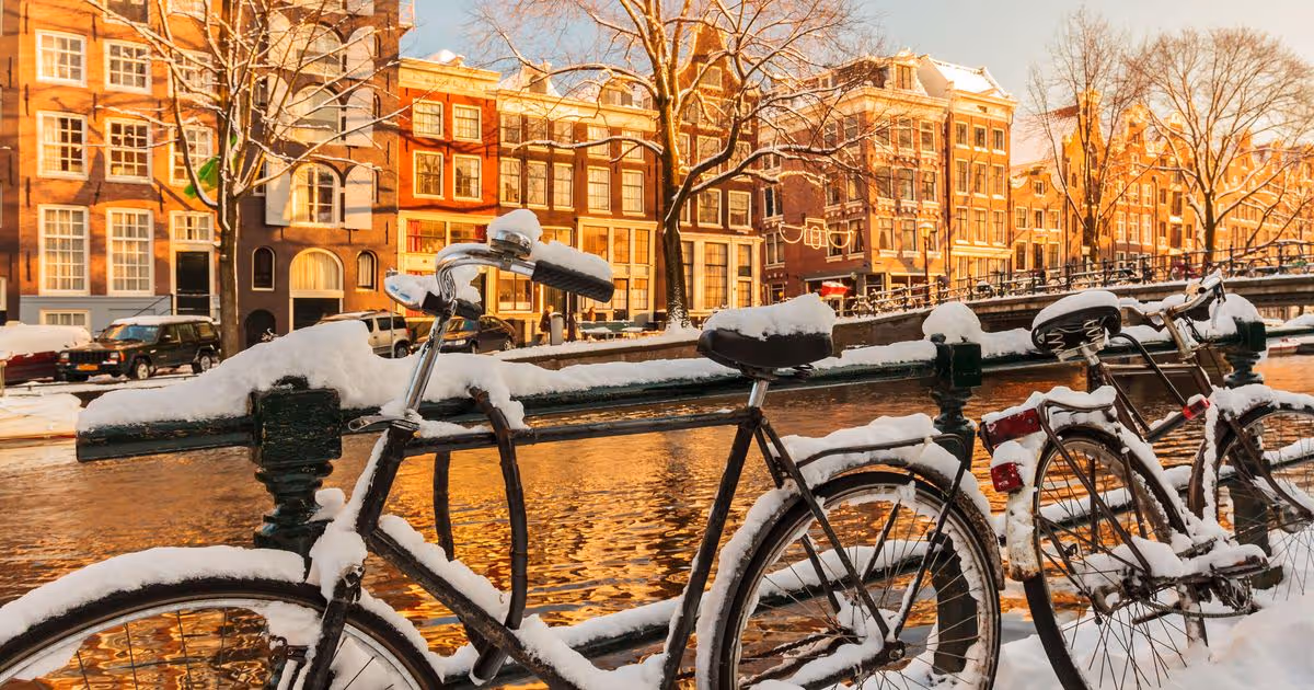 snow on a bike at a canal in Amsterdam