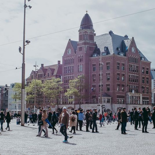 Tourists and pedestrians gathered at Dam Square in Amsterdam