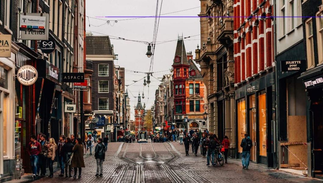 amsterdam tram approaches down a city street