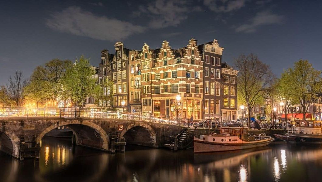 one of the many canals in Amsterdam at night time