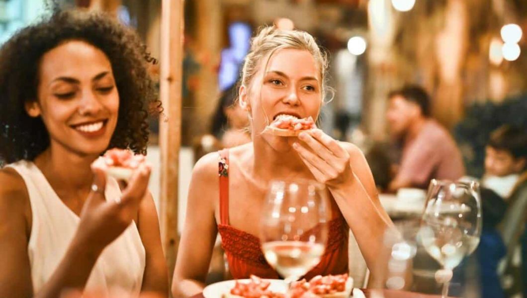 2 women having pizza at a restaurant