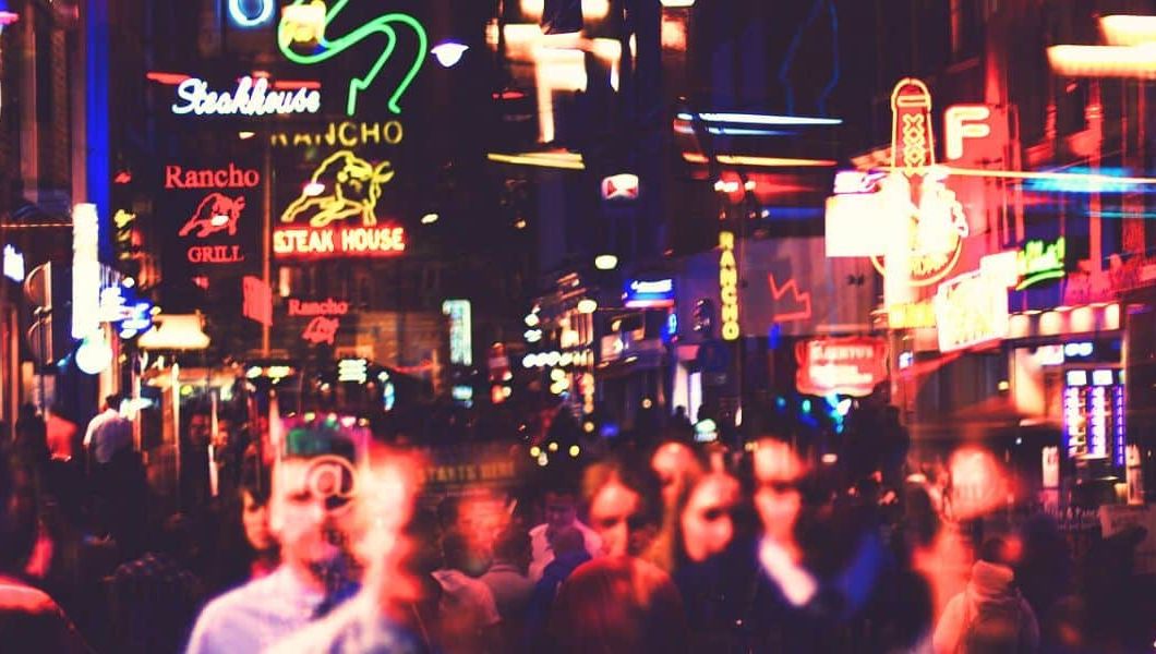a busy street at night in amsterdam