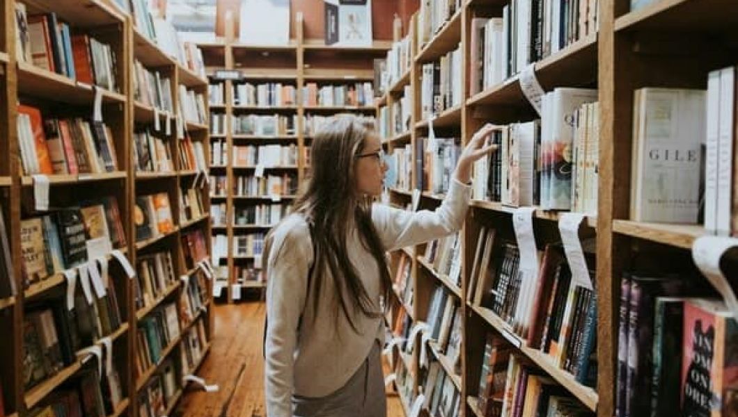 Lady browsing for books in a bookshop