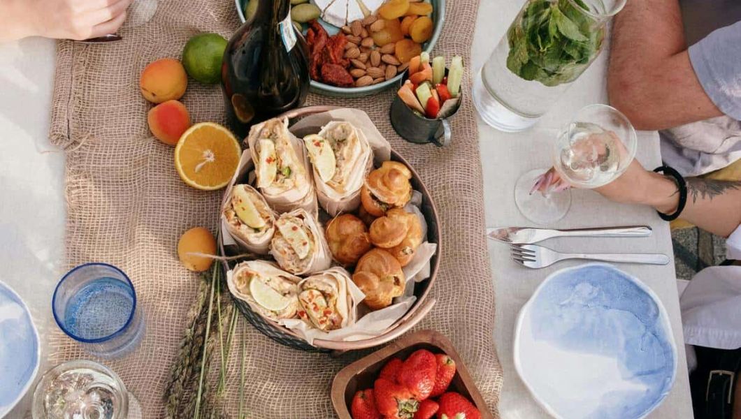 table with brunch items, including fruit, pastries, and drinks.